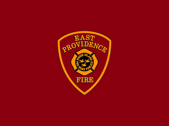 East Providence Fire Department badge: gold shield with a Maltese cross centered on a maroon background.